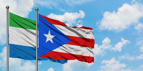 Sierra Leone and Puerto Rico flag waving in the wind against white cloudy blue sky together. Diplomacy concept, international relations.