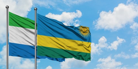 Sierra Leone and Rwanda flag waving in the wind against white cloudy blue sky together. Diplomacy concept, international relations.
