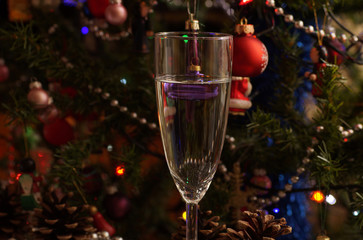 A glass of New Year's champagne on the background of Christmas decorations. New Year.