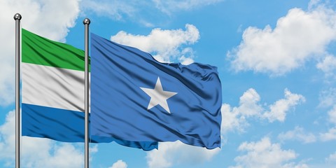Sierra Leone and Somalia flag waving in the wind against white cloudy blue sky together. Diplomacy concept, international relations.