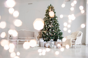 Classic christmas New Year decorated interior room New year tree. Christmas tree with gold decorations. Modern white classical style interior design