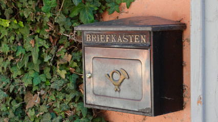 Old historic mailbox in Germany with postilion horn symbol