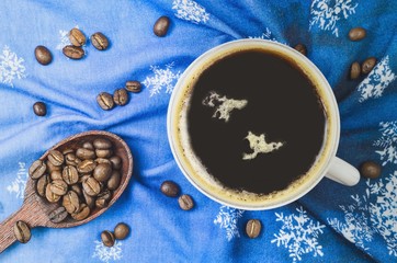 Winter concept with serving coffee. Black coffee on a blue background.