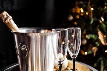 Holiday set. Champagne in a cooling bucket with glasses for couples in love.