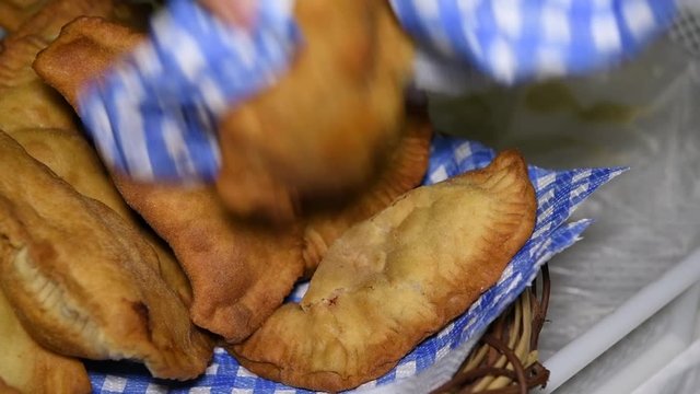 Homemade fresh and hot freshly made, Apulian panzerotti with tomato, mozzarella and prosciutto cotto in a basket. Panzerotti is a traditional dish in Salento, Puglia, Italy, fried in olive oil