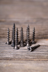  screws on a wooden background