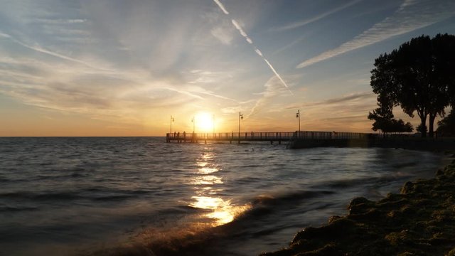 Sunrise Time Lapse Over Pier and Lake, Colorful Sky With Airplane Trails. St. Clair Lake, Tecumseh, Ontario, Canada