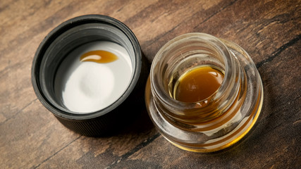 Small glass container of cannabis oil