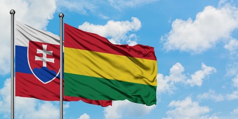 Slovakia and Bolivia flag waving in the wind against white cloudy blue sky together. Diplomacy concept, international relations.