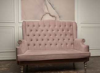 An old sofa on the background of vintage wall