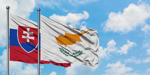 Slovakia and Cyprus flag waving in the wind against white cloudy blue sky together. Diplomacy concept, international relations.