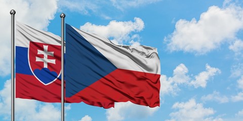 Slovakia and Czech Republic flag waving in the wind against white cloudy blue sky together. Diplomacy concept, international relations.