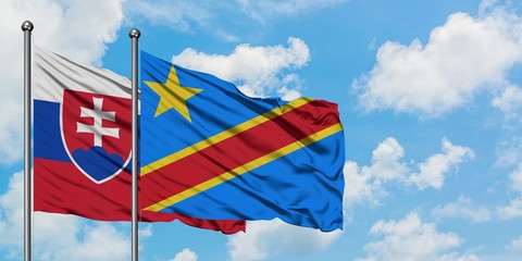 Slovakia and Congo flag waving in the wind against white cloudy blue sky together. Diplomacy concept, international relations.