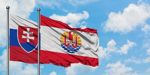 Slovakia and French Polynesia flag waving in the wind against white cloudy blue sky together. Diplomacy concept, international relations.