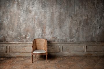 old armchair against a vintage wall