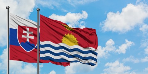 Slovakia and Kiribati flag waving in the wind against white cloudy blue sky together. Diplomacy concept, international relations.
