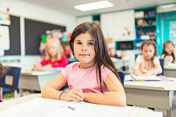 education and school concept little student girl studying at school