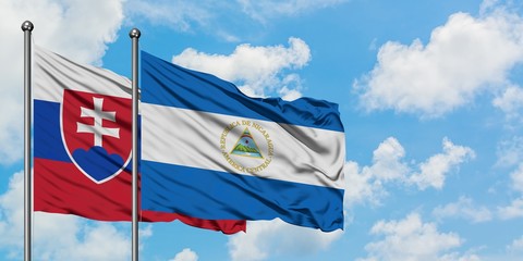 Slovakia and Nicaragua flag waving in the wind against white cloudy blue sky together. Diplomacy concept, international relations.