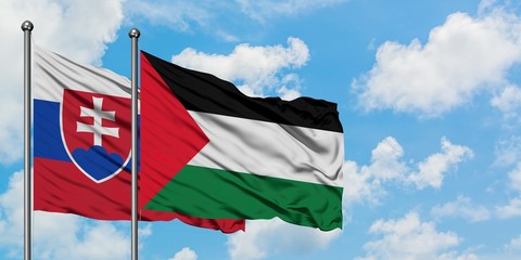 Naklejka na ściany i meble Slovakia and Palestine flag waving in the wind against white cloudy blue sky together. Diplomacy concept, international relations.