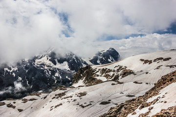 Fototapeta na wymiar high mountains covered with snow and ice, peaks and valleys in the Caucasus