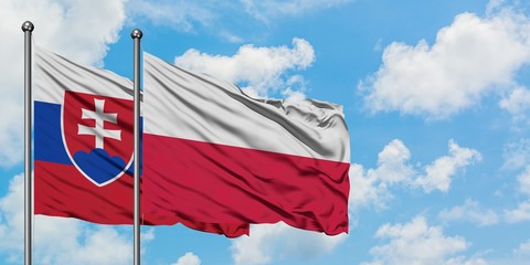 Slovakia and Poland flag waving in the wind against white cloudy blue sky together. Diplomacy concept, international relations.