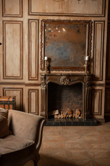 A fireplace and an old mirror in the old interior