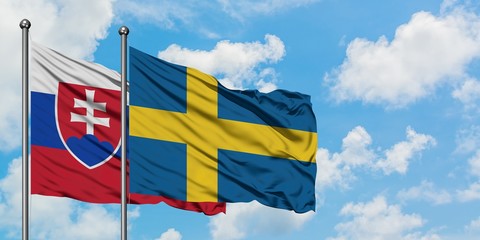 Slovakia and Sweden flag waving in the wind against white cloudy blue sky together. Diplomacy concept, international relations.
