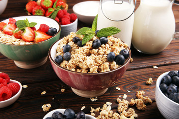 Tasty homemade granola served on table. Healthy breakfast with a bowl of oatmeal with banana, blueberries, strawberries and healthy food for Breakfast