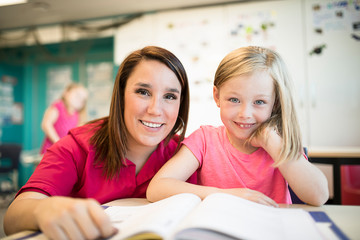 education and school concept little student girl studying at school
