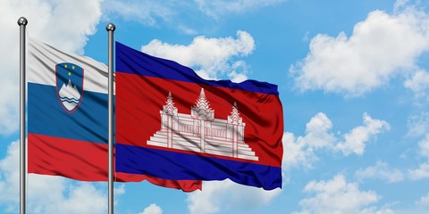Slovenia and Cambodia flag waving in the wind against white cloudy blue sky together. Diplomacy concept, international relations.