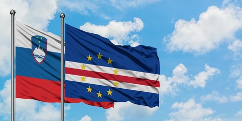 Slovenia and Cape Verde flag waving in the wind against white cloudy blue sky together. Diplomacy concept, international relations.