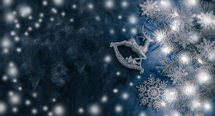 Magic  New Year and Christmas background with snowflakes, garland and fir branches.