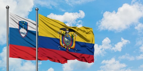 Slovenia and Ecuador flag waving in the wind against white cloudy blue sky together. Diplomacy concept, international relations.