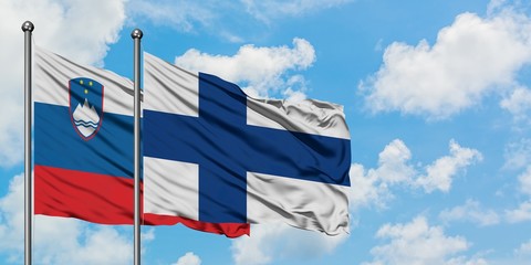 Slovenia and Finland flag waving in the wind against white cloudy blue sky together. Diplomacy concept, international relations.