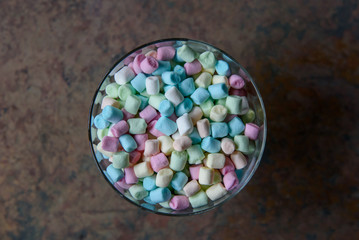 Small pieces of Colorful marshmallows. Sweet candies at dessert dish.