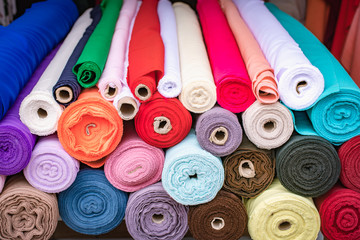Colorful fabric rolls piled at the store