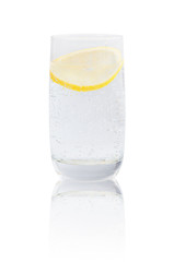 Full glass of gas water with lemon.