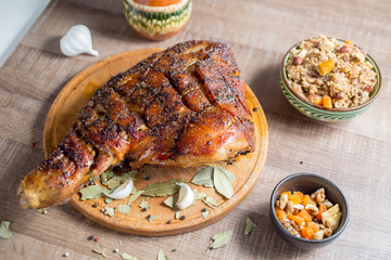 roast pork meat but with a bone on a wooden board