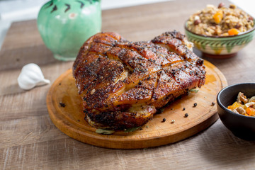 roast pork meat but with a bone on a wooden board