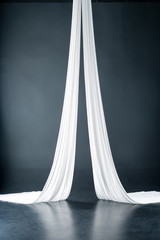 white aerial silks isolated on black background