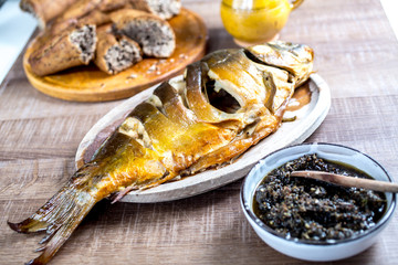 Grilled carp fish on vintage wooden table
