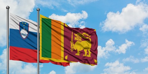 Slovenia and Sri Lanka flag waving in the wind against white cloudy blue sky together. Diplomacy...