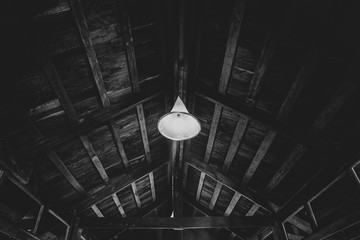 A lamp on the old wooden ceiling roof