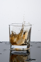 a glass of whiskey, drops, spray, splash of fluid, a stop time, after a hard working day, rest time, Scottish traditions, Irish drink, Bourbon or Scotch,