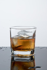 a glass of whiskey, drops, spray, splash of fluid, a stop time, after a hard working day, rest time, Scottish traditions, Irish drink, Bourbon or Scotch,