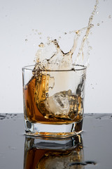 a glass of whiskey, drops, spray, splash of fluid, a stop time, after a hard working day, rest time, Scottish traditions, Irish drink, Bourbon or Scotch,