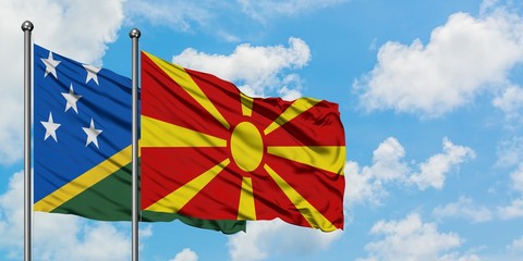 Solomon Islands and Macedonia flag waving in the wind against white cloudy blue sky together. Diplomacy concept, international relations.