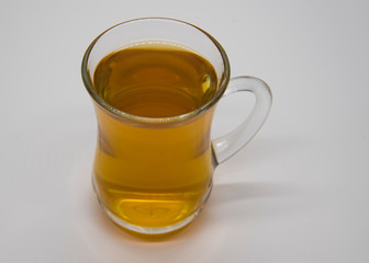 transparent Cup with a drink on a light gray background.
