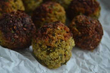 Falafel on white paper. vegan food on a white background. fresh vegan tasty falafel with spices, falafel baked in the oven. chickpeas balls. a source of protein for vegans. 