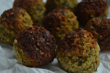 Falafel on white paper. vegan food on a white background. fresh vegan tasty falafel with spices, falafel baked in the oven. chickpeas balls. a source of protein for vegans. 